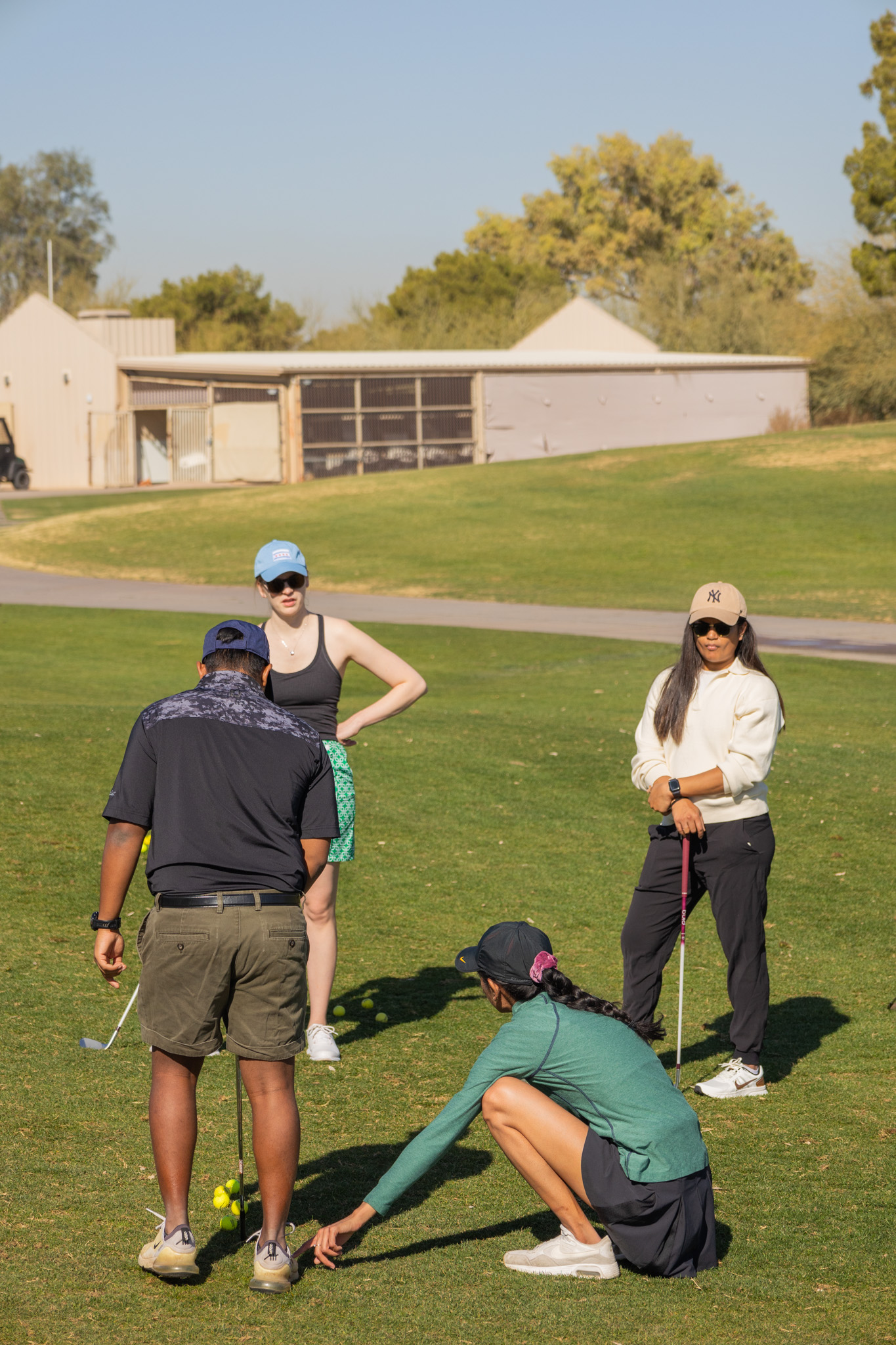 Golf instruction session with students learning proper technique